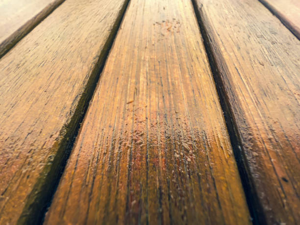 istock Wet light wood of a garden table. 1356148928