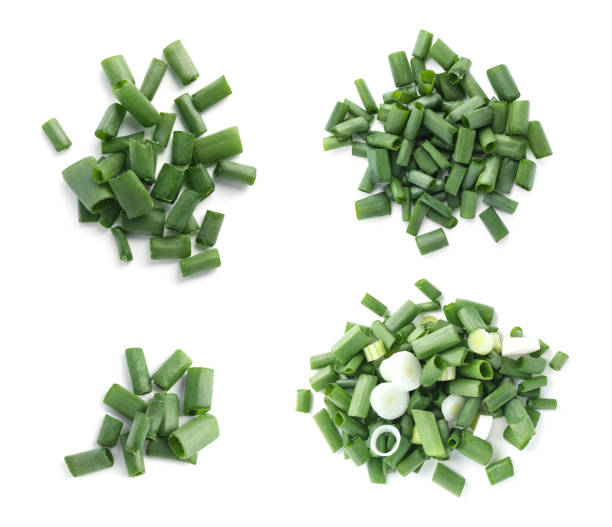 istock Set of cut green onions on white background, top view 1356148932