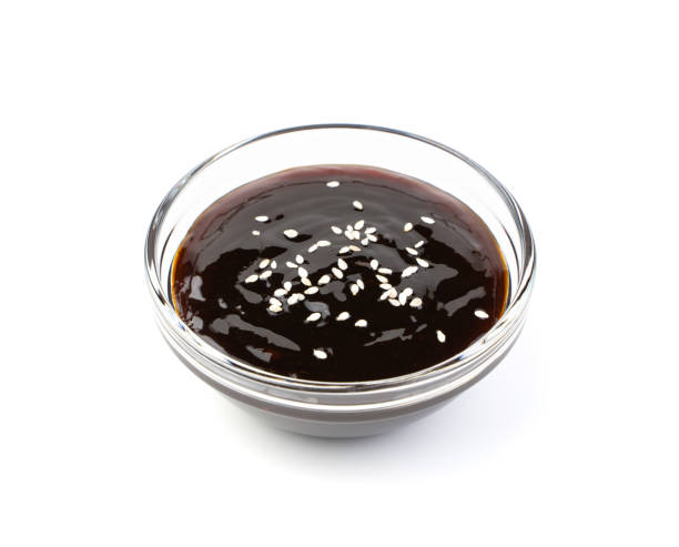 Teriyaki sauce with sesame seeds isolated on a white background Teriyaki sauce with sesame seeds isolated on a white background. Side view. teriyaki stock pictures, royalty-free photos & images