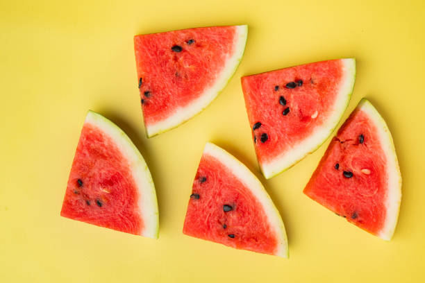 istock Watermelon cut, on yellow textured summer background, top view flat lay 1356150055