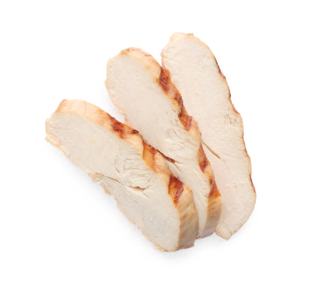 Slices of tasty grilled chicken fillet isolated on white, top view Slices of tasty grilled chicken fillet isolated on white, top view chicken breast stock pictures, royalty-free photos & images