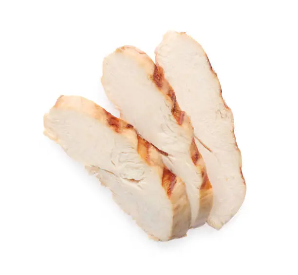 Photo of Slices of tasty grilled chicken fillet isolated on white, top view