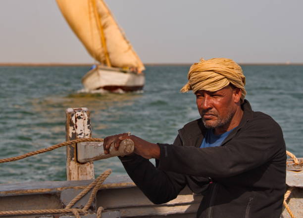 Iwik. Mauritania. October 08, 2021. A fisherman from a fishing village operates a sailing sea launch in the waters of the Banc National Nature Park on the West coast of Africa.