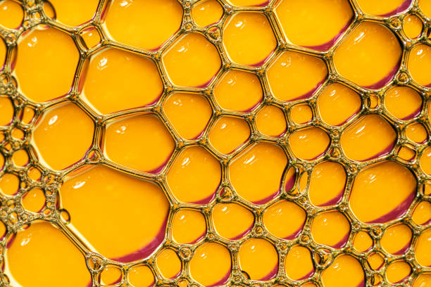 istock Orange oil or serum background with bubbles. 1356152234