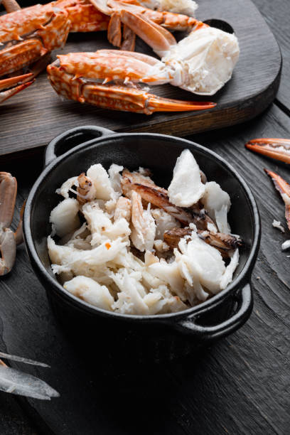 istock Mixed brown white crabmeat boiled set, on black wooden table background 1356153014