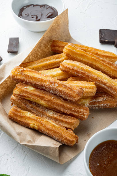 istock Typical Spanish snack  churros, fried-dough pastry served  usually with chocolate caramel hot sauce, on white background 1356154695