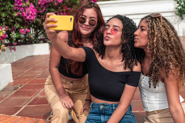 istock Three Latin friends having fun outdoors 1356156758