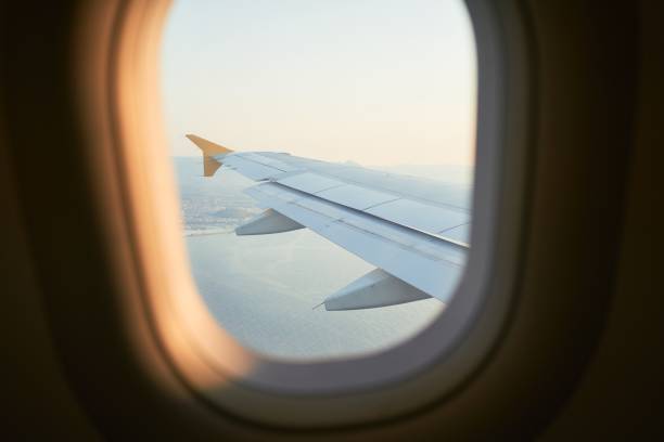 istock Cloudscape from window airplane, landscape of wing plane on a cloudy sky 1356158095