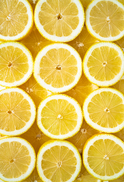 istock Lemon fruit slices arrangement in a row full frame background 1356158267