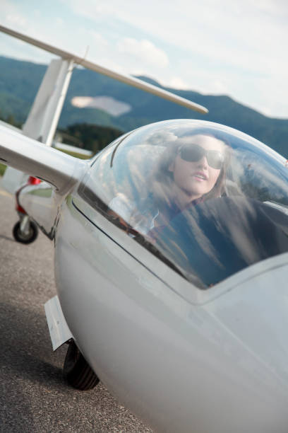 istock Young woman in glider plane 1356159151