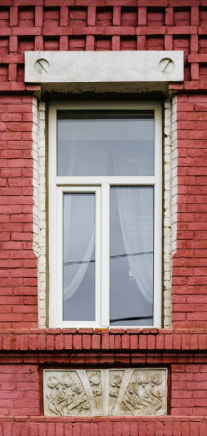 istock A modern plastic double-glazed window in the window of an old brick building with elements of stucco decoration 1356159602