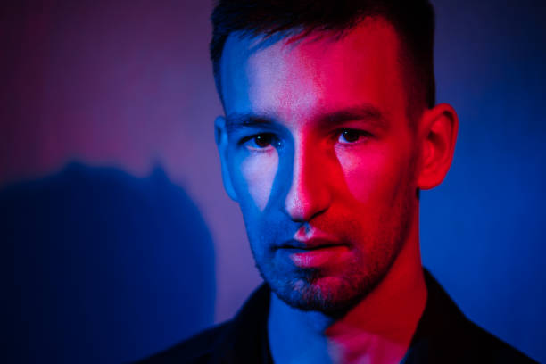 istock male portrait in neon light. 1356159671