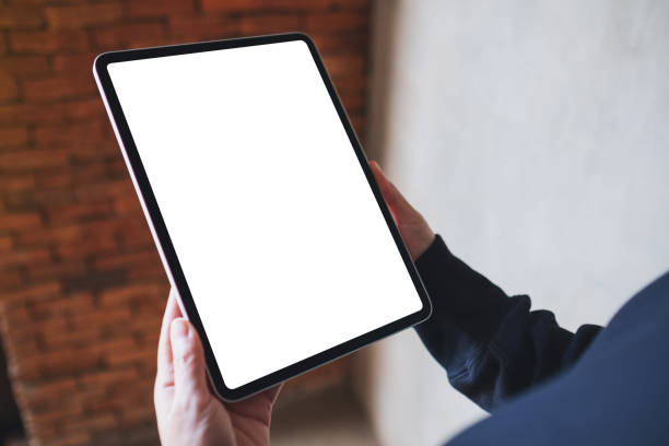 istock a woman holding digital tablet with blank white desktop screen 1356159739