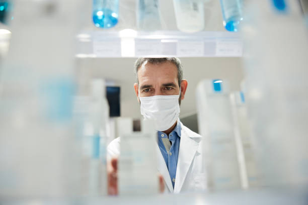 istock A pharmacist wearing a protective face mask is ordering a shelf. 1356159920