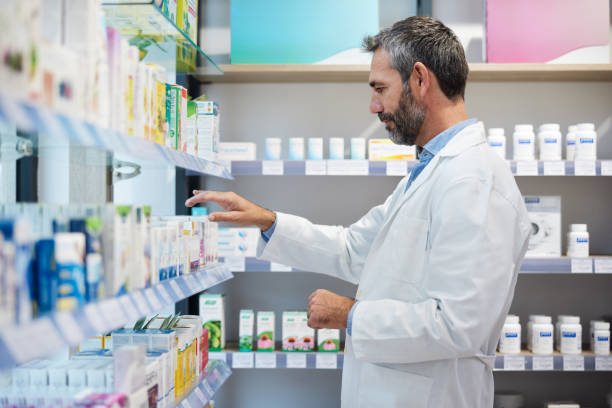 istock A pharmacist is sorting products on the shelves. 1356160039