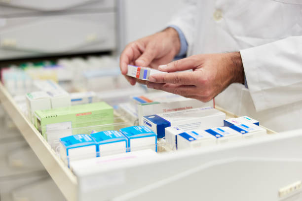 storing pills in a capsule medicine drawer in a pharmacy's backroom. - pharmacist pharmacy pill medicine imagens e fotografias de stock