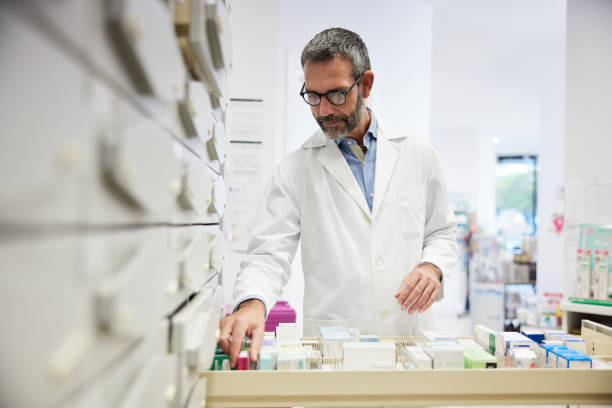 istock A pharmacist stores drugs in the storage drawers. 1356160746