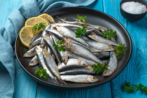 istock A dish with salted sprat with lemon and parsley on a blue background 1356161138