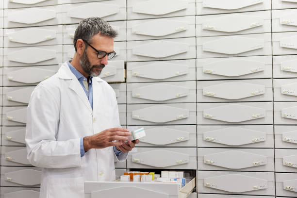 istock A pharmacist sorts products in the backroom drawers. 1356161167