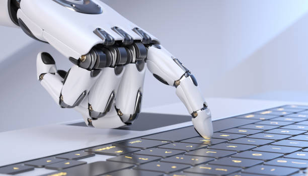 istock White robot cyborg hand pressing a keyboard on a laptop 1356162320