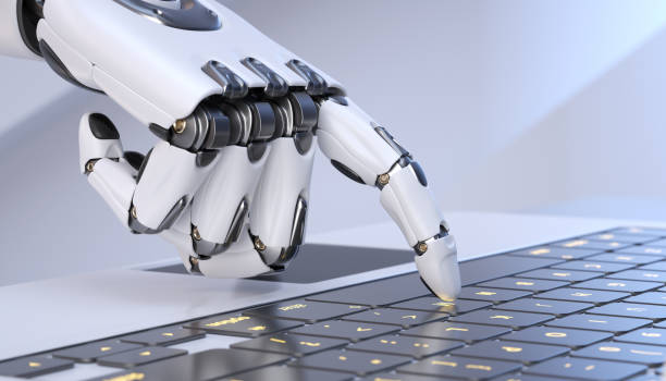 White robot cyborg hand pressing a keyboard on a laptop stock photo