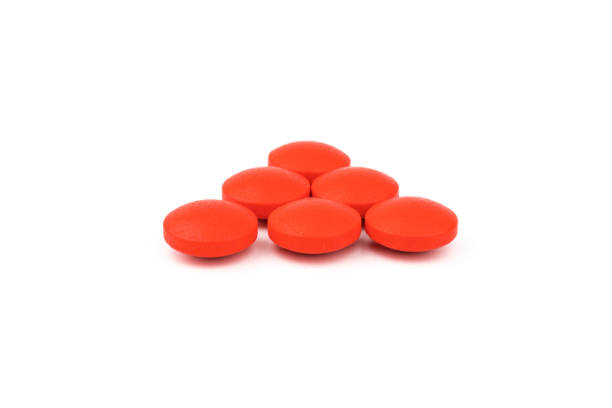 istock Red pills on a white background, isolated. Pharmacy. Treatment. 1356162528