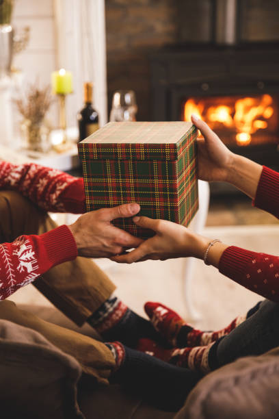 istock Romantic couple exchanging a Christmas gift 1356162630