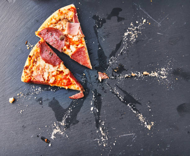 istock Slices of italian pizza on blackboard surface 1356162644