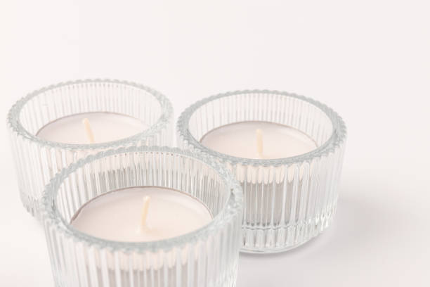 istock Tea candles in a glass candlestick, isolated on white. Space for text 1356162825