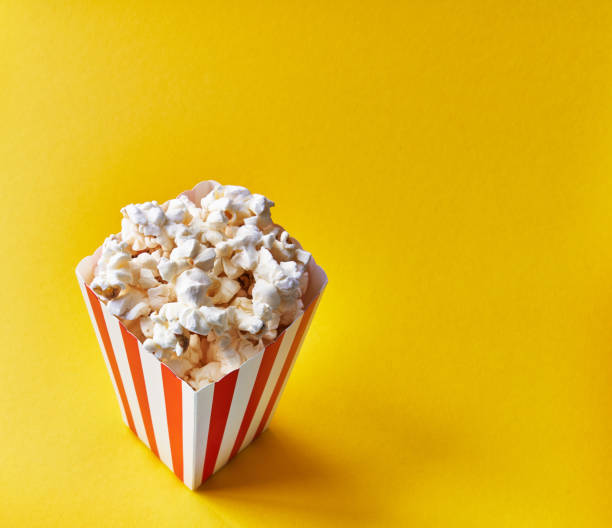 istock Pack of salty popcorns on a yellow background 1356162867