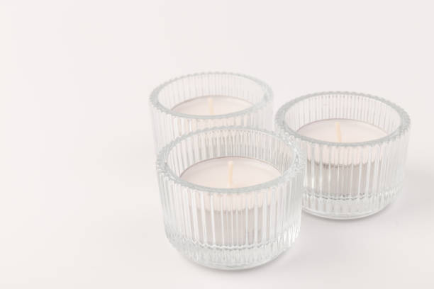 istock Tea candles in a glass candlestick, isolated on white. Space for text 1356163002