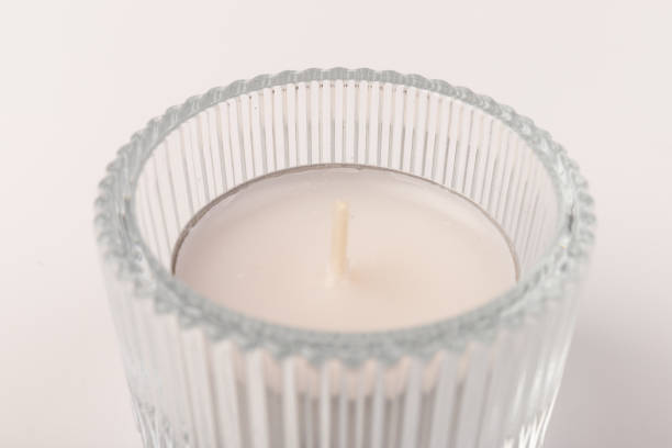 istock Tea candles in a glass candlestick, isolated on white. Space for text 1356163004