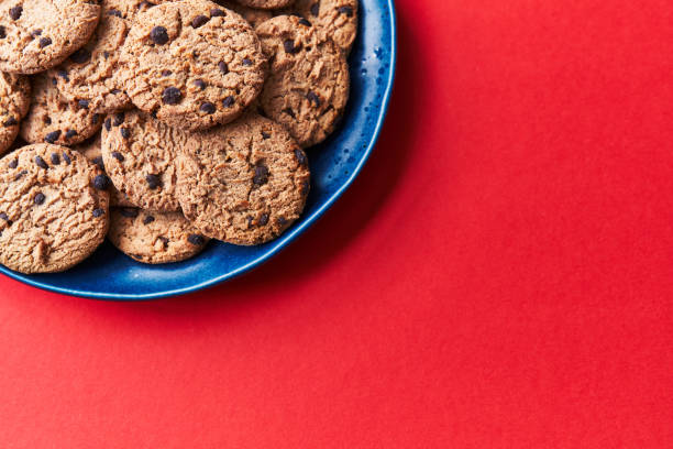 istock Plate of chocolate cookies on a red background 1356163246