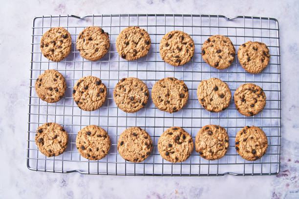istock Chocolate cookies served on a grid rack on a marble table 1356163282