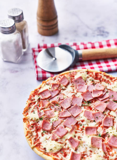 istock Delicious prosciutto italian pizza on a marble surface 1356163416