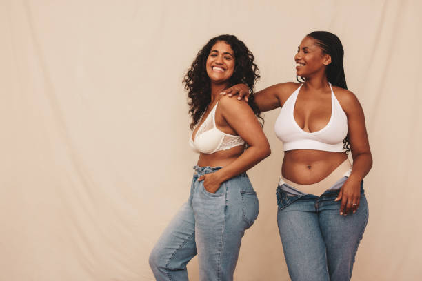 istock Smiling female friends standing together in a studio 1356163498