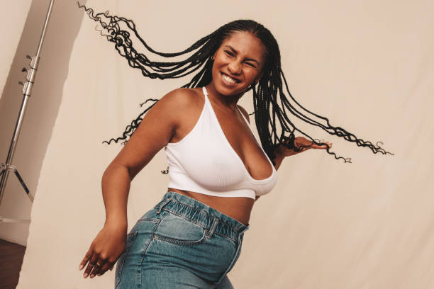 istock Cheerful young woman celebrating being natural in a studio 1356163537