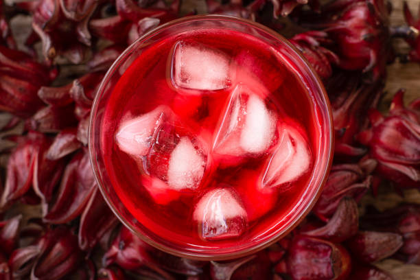Sorrel juice or hibicus tea with roselle flowers. Sorrel juice or hibicus tea with roselle flowers. Top view. Flat lay. red drink stock pictures, royalty-free photos & images