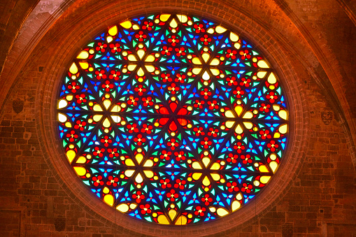 Colored rose window in Palma de Mallorca cathedral. Spain