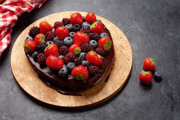 istock Heart shaped sweet cake with berries 1356165886