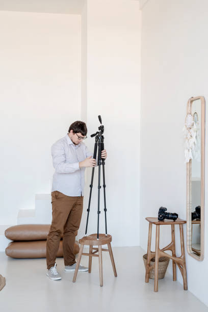 istock Male photographer working in minimal light and airy interior 1356166095