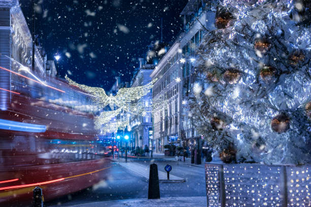 Conceptional view of London during christmas winter time Conceptional view of London during christmas winter time with blurred street traffic, ice and defocused, falling snow during night time winter wonderland london stock pictures, royalty-free photos & images