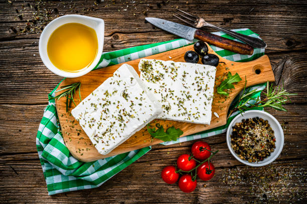 istock Greek feta cheese blocks on rustic wooden table 1356167355