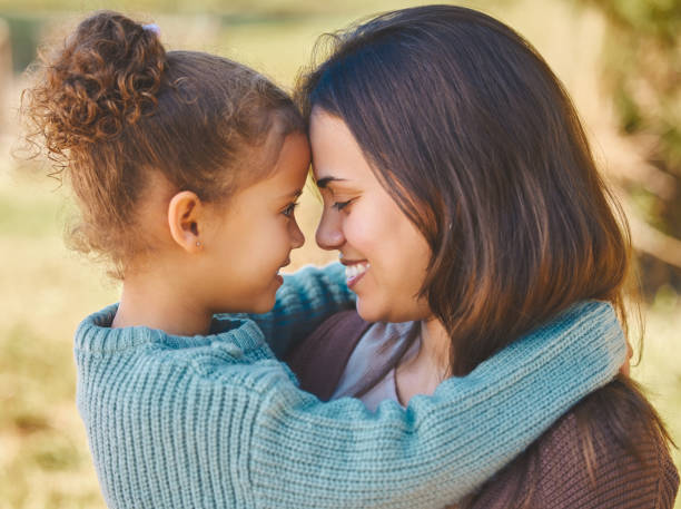istock Shot of a young mother affectionately hugging during a picnic 1356167484
