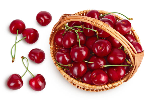 istock red sweet cherry in wicker basket isolated on white background with clipping path and full depth of field, Top view. Flat lay 1356169025