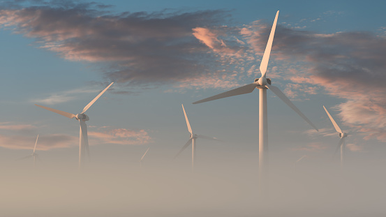 Wind farm against the backdrop of a picturesque sky on a foggy morning. Green energy topics