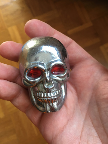 Metal skull with red eyes, holding in a hand
Taken on mobile device, iPhone 6s