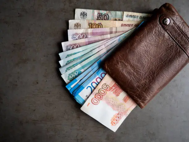 Russian money. Close-up of a leather wallet full of banknotes 5000, 2000, 3000, 500 rubles. The money is in your wallet.