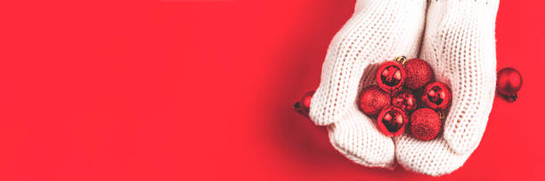 istock Red balls lie in women's hands in white mittens. 1356174098