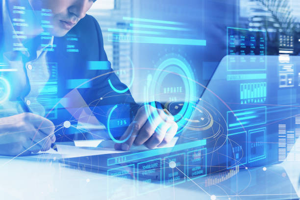 istock Businessman is taking notes in front of laptop with hologram 1356174266